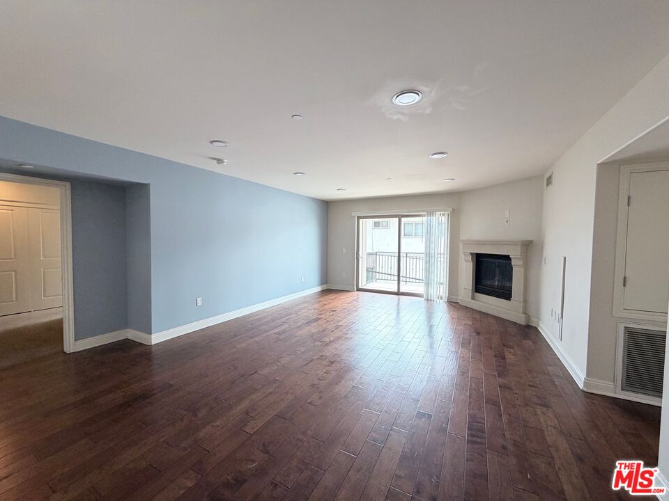 8238 West Manchester Avenue, Unit 308 Playa del Rey, CA 90293 - Photo 4 of 19 a view of an empty room with wooden floor and a window