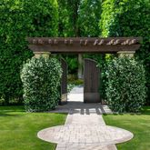 a view of a patio with table and chairs potted plants and floor to ceiling window