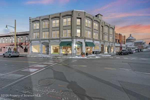 a living room with patio furniture and a flat screen tv