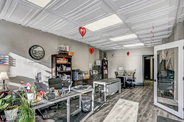 a living room with furniture a rug and a flat screen tv