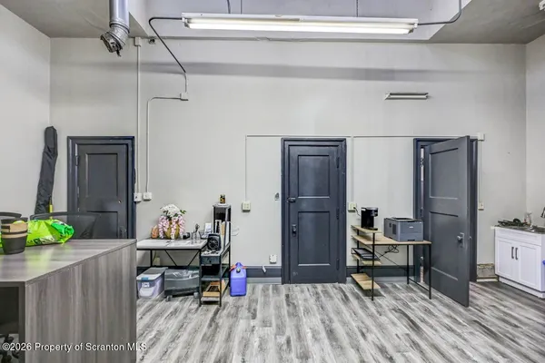 a living room with furniture a rug and white walls