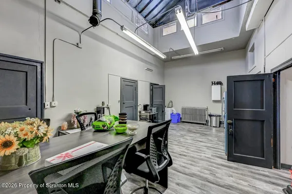a view of a livingroom with wooden floor and a flat screen tv