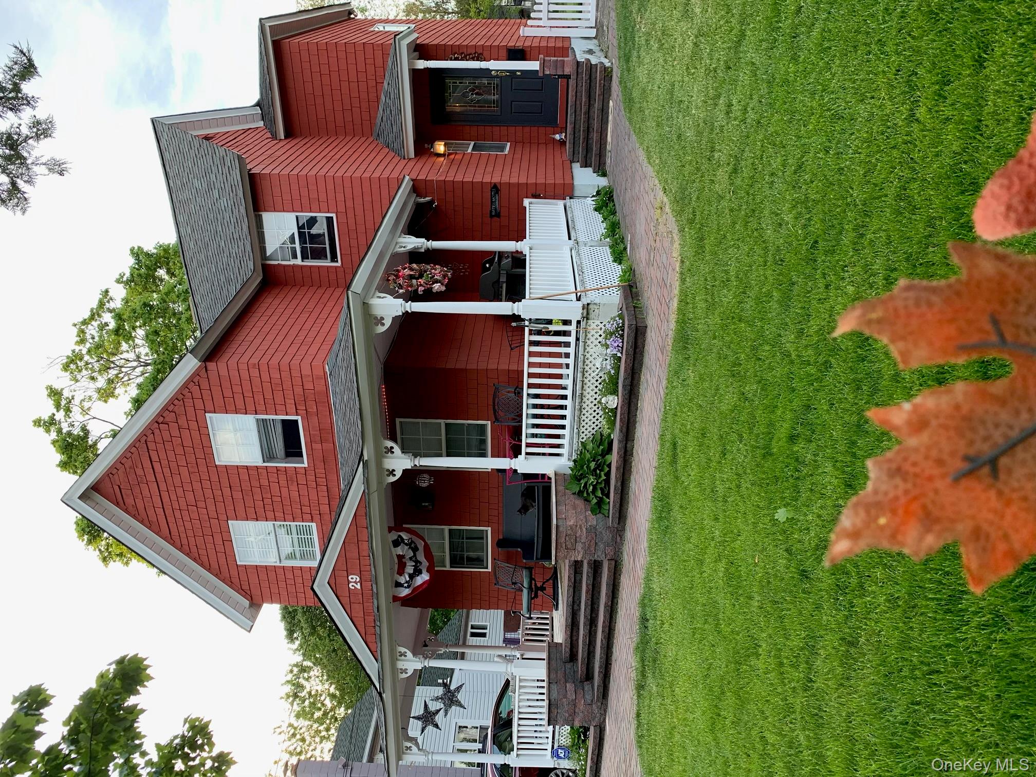 a front view of a house with a garden and yard