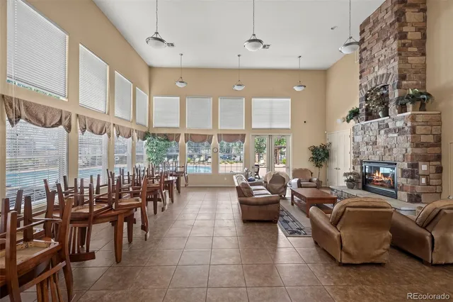 a living room with fireplace furniture and a large window