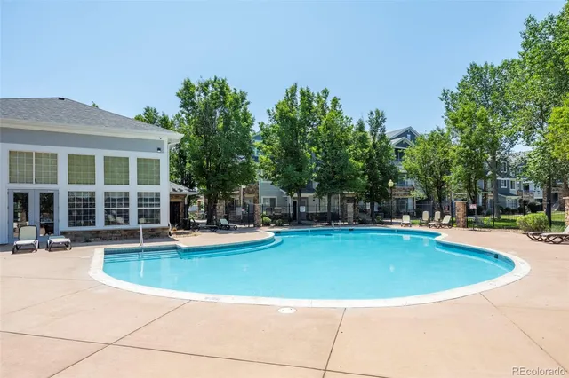 a view of a swimming pool with sitting area