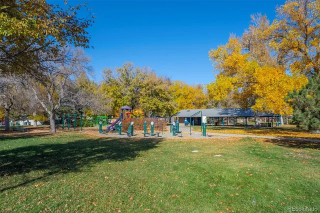 a view of a house with a big yard and large trees