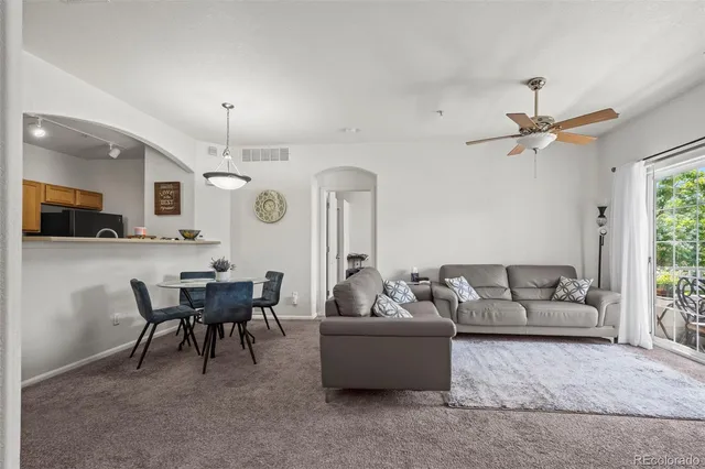 a living room with furniture and a chandelier