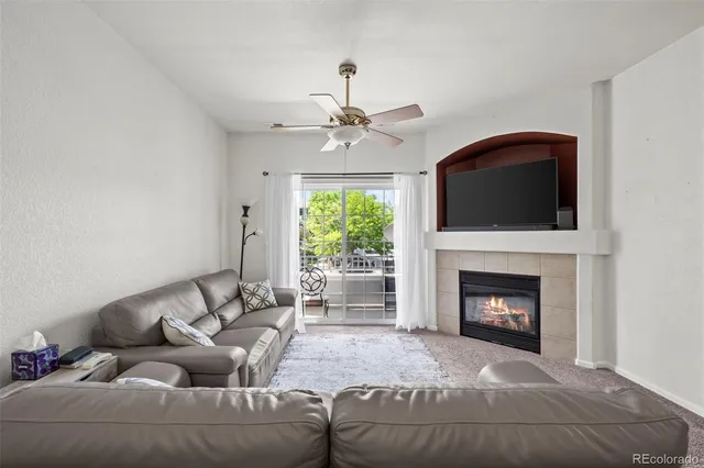 a living room with furniture and a fireplace