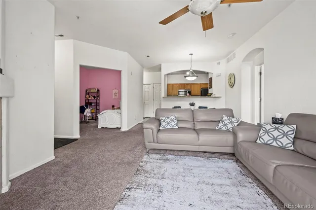 a living room with furniture and a chandelier