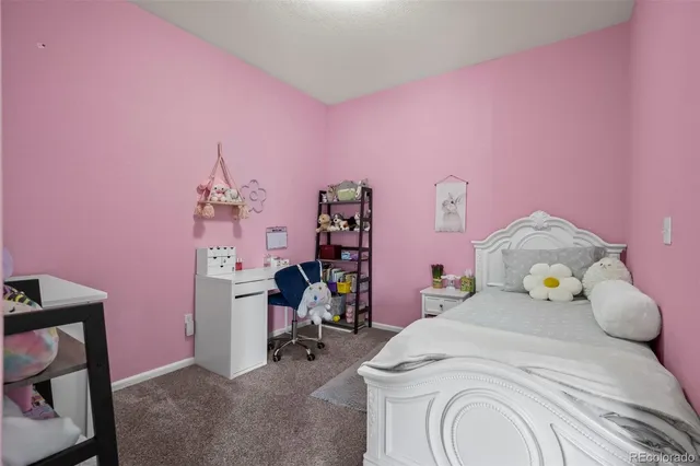 a bedroom with a bed and a desk