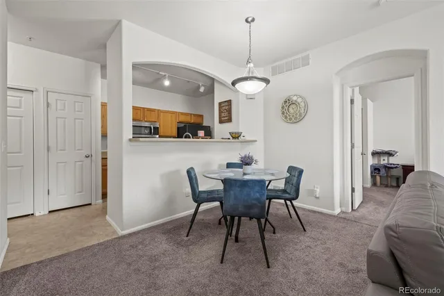 a view of a dining room with furniture and chandelier