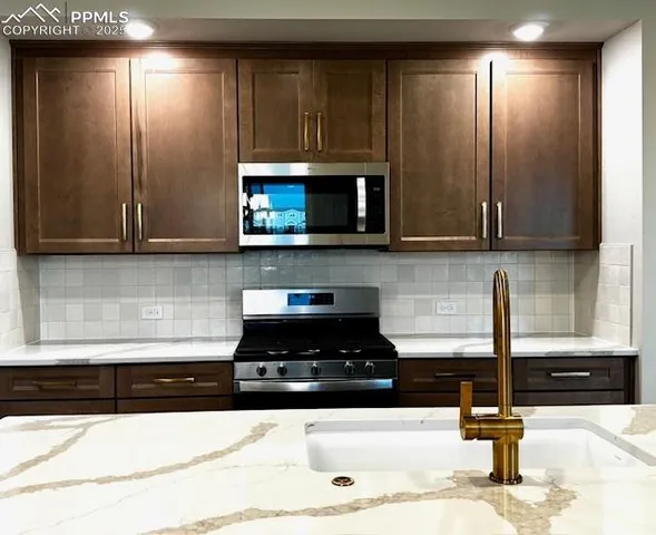 a kitchen with a sink and a microwave