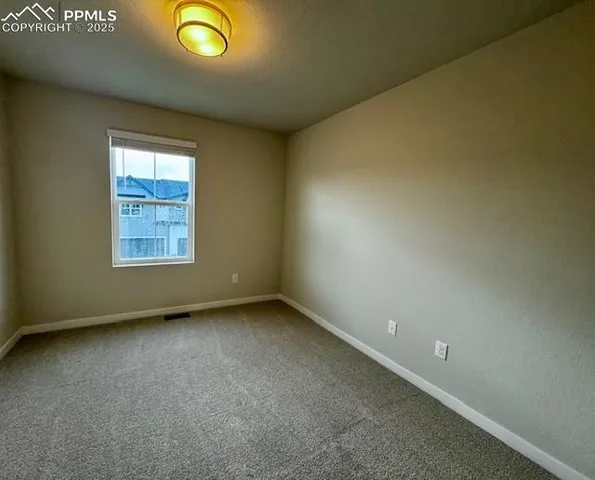 an empty room with a empty space and a window
