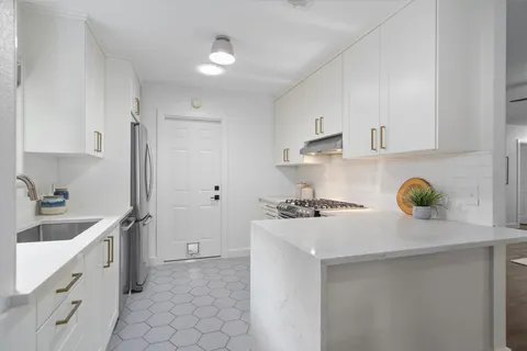 a kitchen with a sink cabinets and appliances