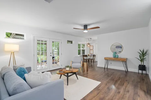 a living room with furniture a window and a table
