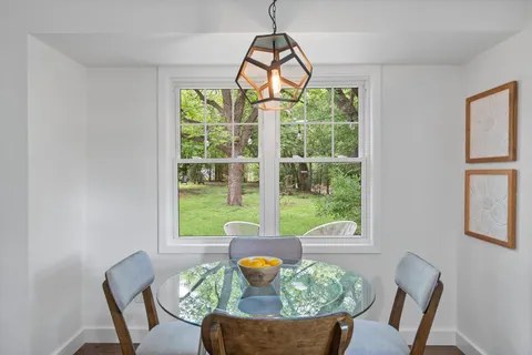 a view of a dining room with furniture window and outside view