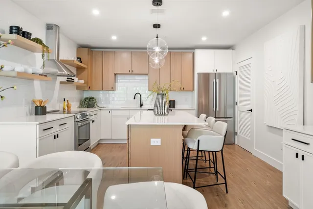a kitchen with a table chairs sink and cabinets