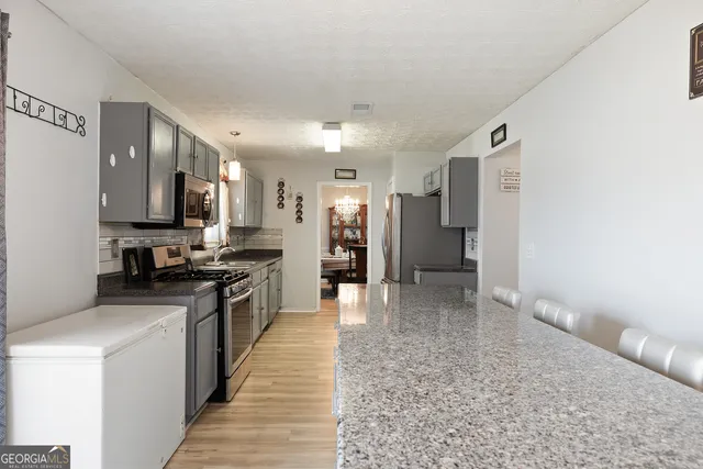 a large kitchen with cabinets and stainless steel appliances