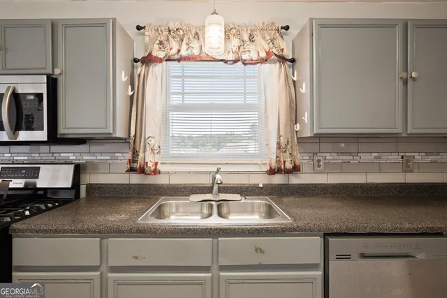 a kitchen with granite countertop a sink and a window