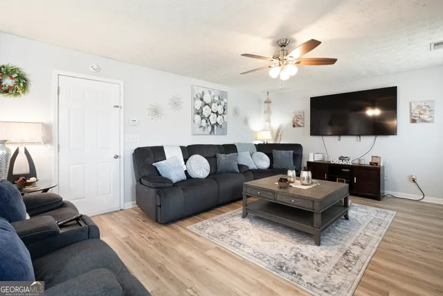 a living room with furniture and a flat screen tv