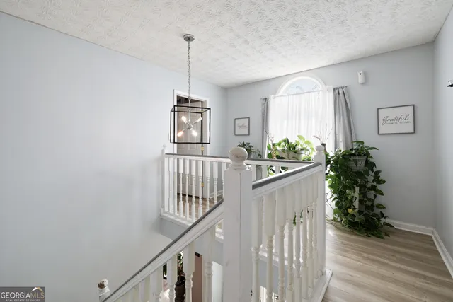 a view of entryway and hall with wooden floor