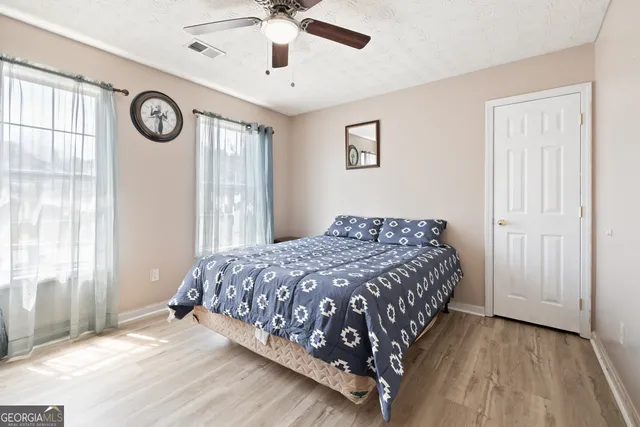 a bedroom with a large bed and a window