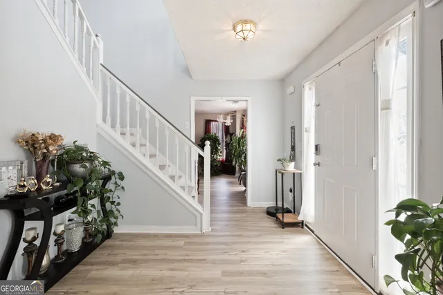 a view of entryway and hall with wooden floor
