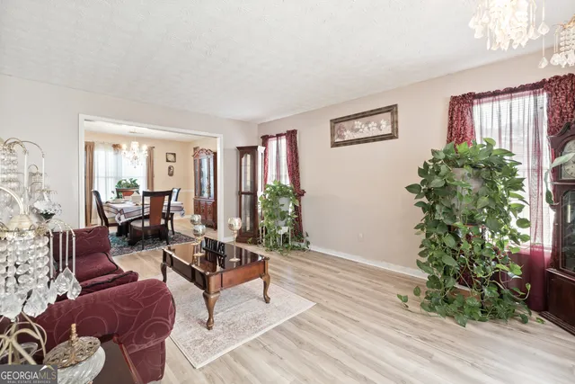 a living room with furniture plant and a window
