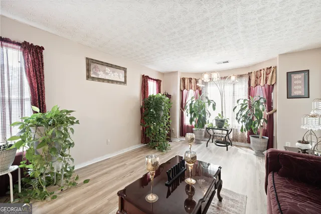 a living room with furniture potted plant and a window