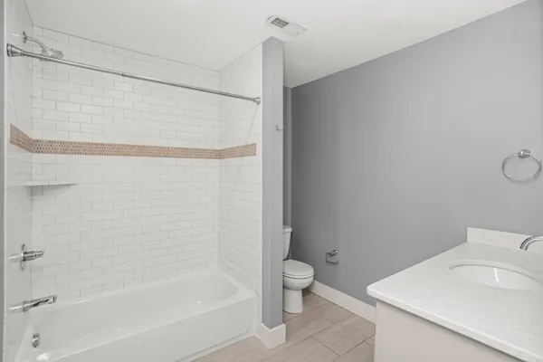 a bathroom with a bathtub and toilet