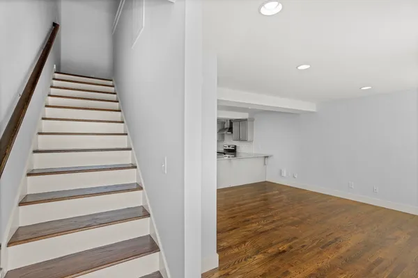 a view of entryway and hall with wooden floor