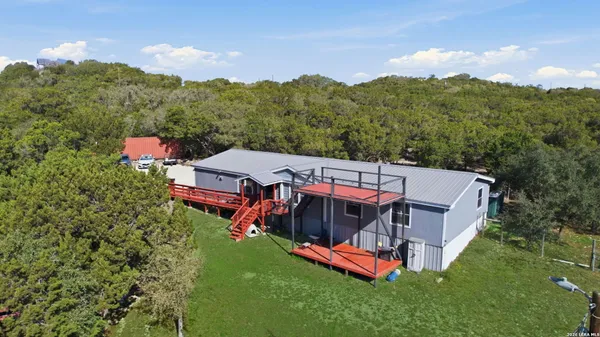 an aerial view of a house with a big yard