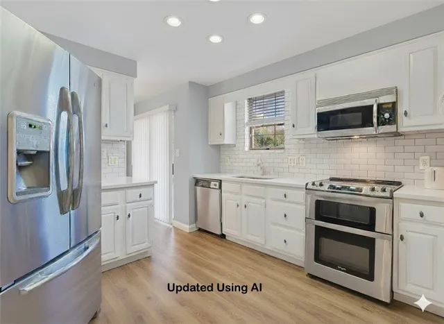 a large kitchen with a sink appliances and cabinets