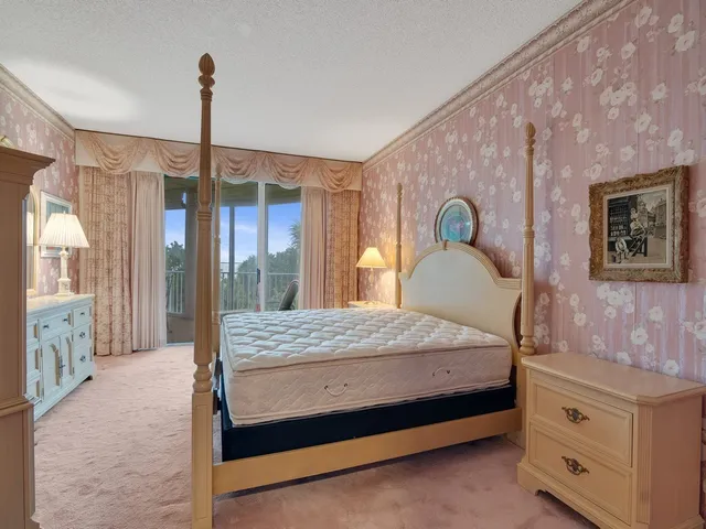 a bedroom with a large bed and a window