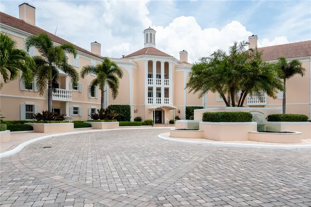 a front view of a house with a yard and palm tree