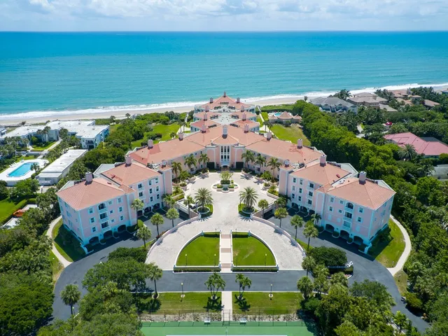 an aerial view of a house with a swimming pool outdoor seating and yard