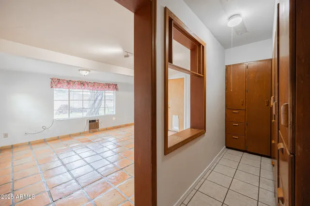 a view of an entryway with a floor to ceiling window and wooden floor