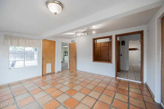 a view of a room with wooden floor and a ceiling fan