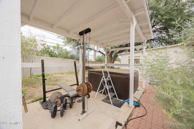 a tree in front of a white house