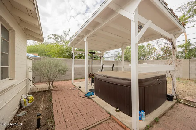 a view of backyard of house with outdoor seating