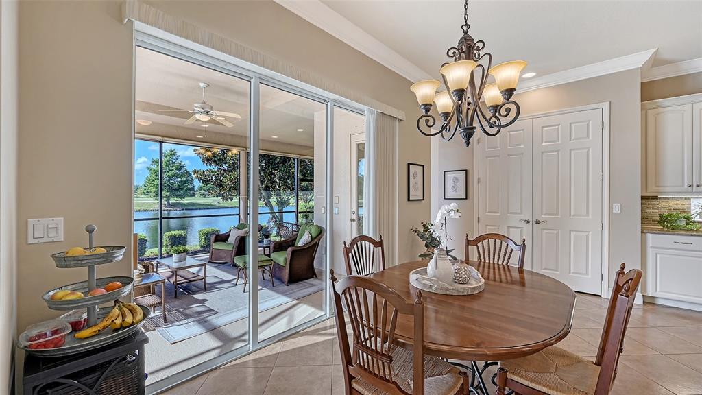 14718 Secret Harbor Place Lakewood Ranch, FL 34202 - Photo 20 of 73 a view of a dining room with furniture window and outside view