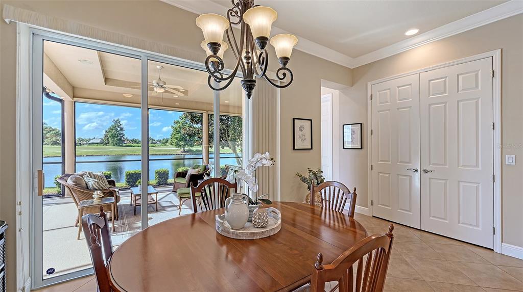 14718 Secret Harbor Place Lakewood Ranch, FL 34202 - Photo 21 of 73 a view of a dining room with furniture window and outside view