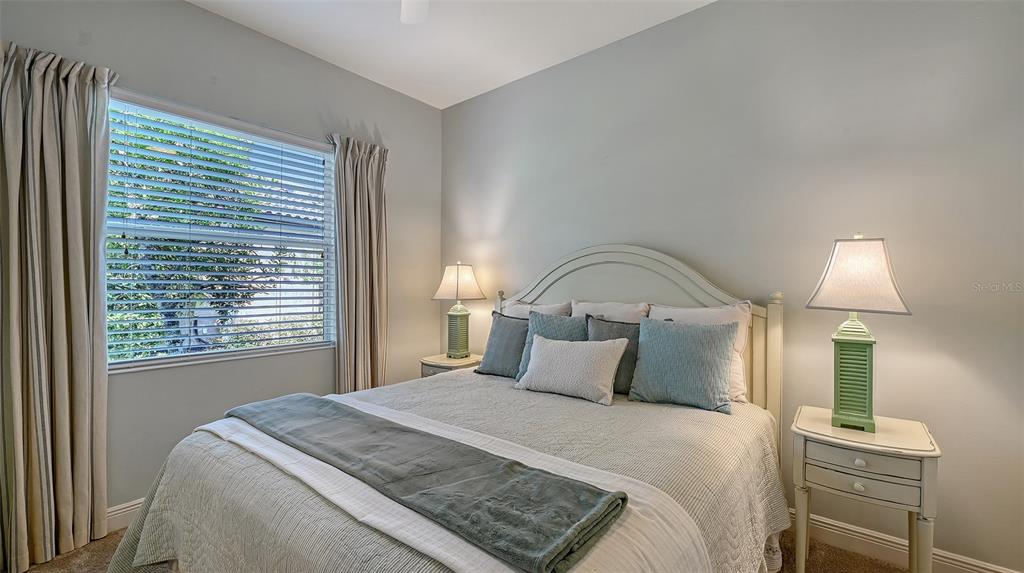 14718 Secret Harbor Place Lakewood Ranch, FL 34202 - Photo 33 of 73 a bedroom with a bed and a night stand