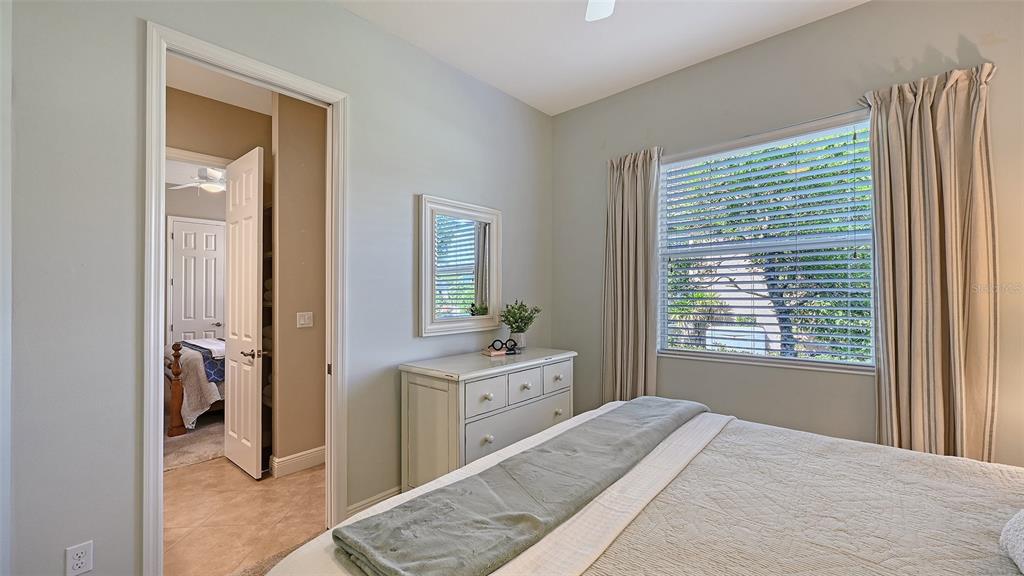 14718 Secret Harbor Place Lakewood Ranch, FL 34202 - Photo 35 of 73 a bedroom with a bed and a window