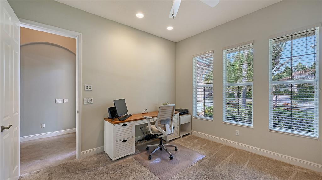 14718 Secret Harbor Place Lakewood Ranch, FL 34202 - Photo 39 of 73 a view of a workspace with furniture and a window