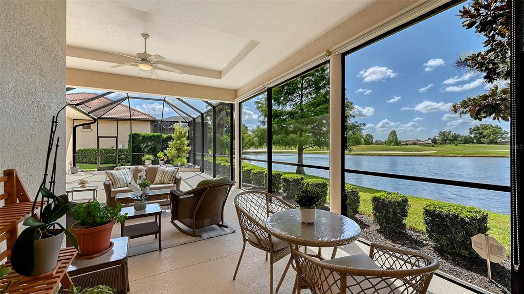 14718 Secret Harbor Place Lakewood Ranch, FL 34202 - Photo 47 of 73 a view of a patio with couches potted plants and a table