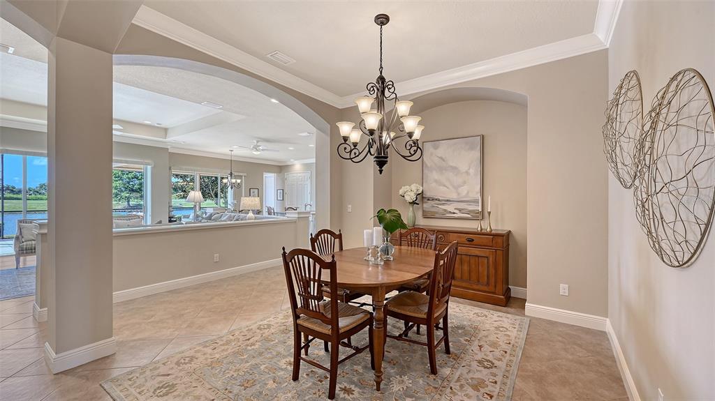 14718 Secret Harbor Place Lakewood Ranch, FL 34202 - Photo 9 of 73 a view of a dining room with furniture and window