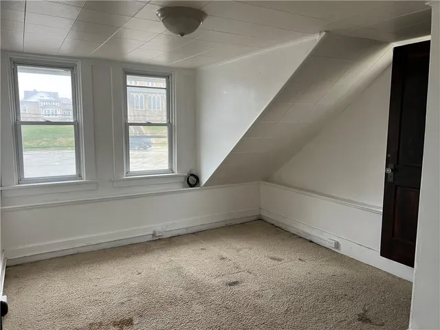 an empty room with a empty space and windows