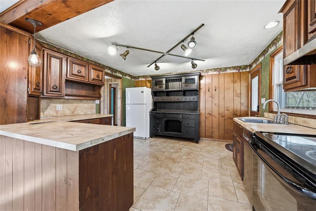 192 Yellow Creek Road Harmony, PA 16037 - Photo 9 of 41 a kitchen with a stove and a refrigerator