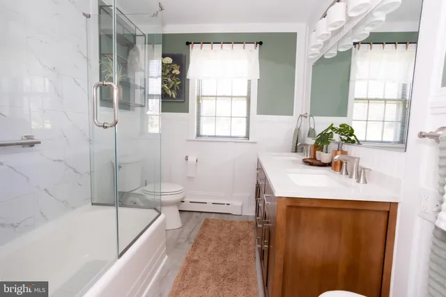 a bath room with a sink bath tub and a shower